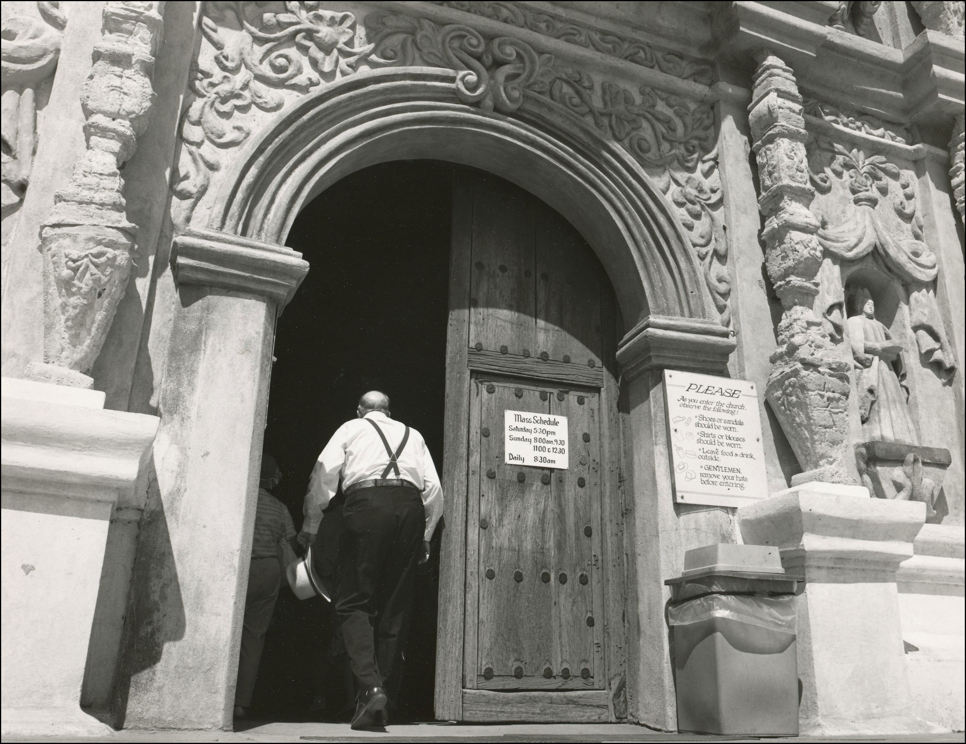 Man walking into the door of a sanctuary